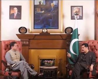 Bakhtiar Khattak in a seated conversation with a public figure