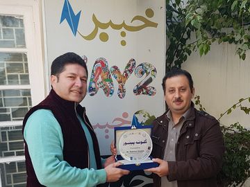 Receiving the Guloona Pekhawar campaign award at AVT Khyber, Peshawar